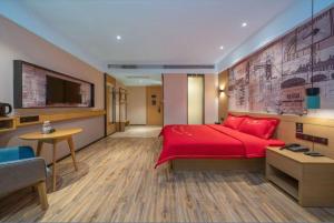 a bedroom with a red bed and a tv at City Comfort Inn Dongguan Gaobu Avenue in Dongguan