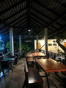 a group of tables and chairs in a restaurant at Sathu Hotel in Chiang Mai