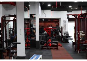 einen Fitnessraum mit vielen Geräten in einem Zimmer in der Unterkunft Al Reef Modern Escape -Sleek, Sunny & Serene in Abu Dhabi