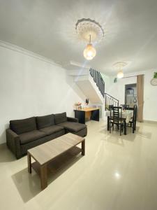 a living room with a couch and a table at Private Room in Villa Near Nusa Dua Beach Bali in Nusa Dua