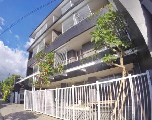 un edificio con una valla blanca delante de él en Pondok Nyaman 15, en Denpasar