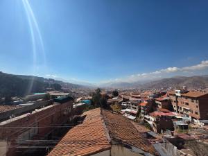 a view of a city with buildings and mountains at All Sur cusco in Cusco