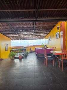 a dining room with tables and chairs in a building at All Sur cusco in Cusco