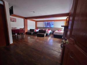 a living room with two couches and a table at All Sur cusco in Cusco +6 photos