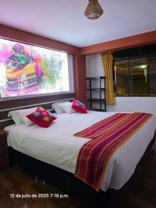 a bedroom with a large bed with a window at All Sur cusco in Cusco