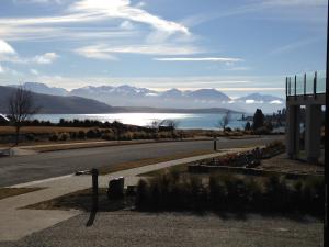 an empty road with a view of a lake and mountains at Simply Stunning Studio 1 in Lake Tekapo