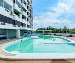 a swimming pool in front of a building at Sea View and Hill View Room for 6 Guests, Bangsaen Royal Beach by Cozy Corner in Ban Laem Thaen