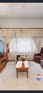 a living room with a couch and a coffee table at Aeris Country Cottage in Junee