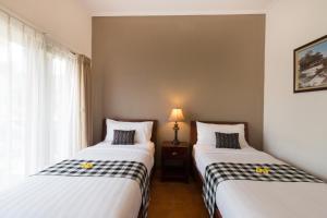 Postel nebo postele na pokoji v ubytování Vidi Boutique Hotel