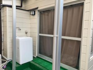 a screened in porch with a toilet and a window at Sweet house Tobu Nerima 001 in Tokyo +31 photos