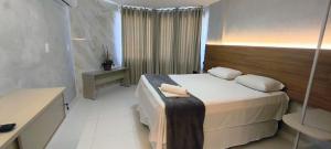 En eller flere senge i et værelse på Victory Tambaú