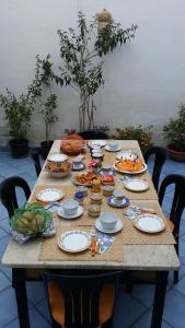 a wooden table with plates and food on it at B&B Albatros in Lipari