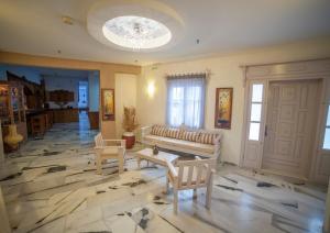 a living room with a couch and a table and chairs at St.George Valsamitis in Katapola