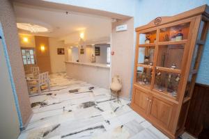 a room with a wooden cabinet and a kitchen at St.George Valsamitis in Katapola