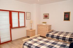 a bedroom with two beds and a dresser and a window at Bed & Fishing House in Slap ob Idrijci