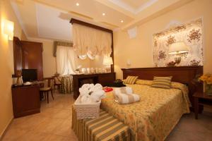Postel nebo postele na pokoji v ubytování Hotel Astigiana & Appartamenti