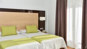 Postel nebo postele na pokoji v ubytování Hotel Baviera