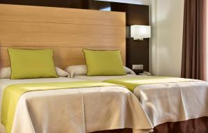 Postel nebo postele na pokoji v ubytování Hotel Baviera