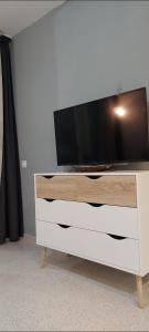 a white dresser with a tv on top of it at Playa del ingles Tamaran apartamento 509 in Maspalomas