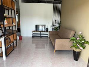 a living room with a couch and a table at Sofya Homestay Kangar in Kangar