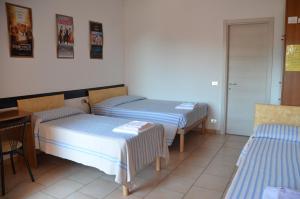 Postel nebo postele na pokoji v ubytování Albergo Roma