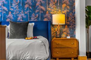 a bedroom with a bed and a nightstand with a lamp at Perfect Location Hot Tub Heated Pool Steam Room Gym in Mount Crested Butte