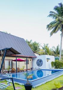 a house with a swimming pool in front of a house at Ramya Ru Nature Resort in Galle