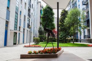 a bronze statue of a bird in a courtyard at Alessia's Flat - Breno 1 in Milan