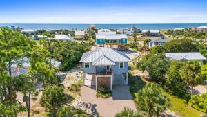 an aerial view of a house with the ocean in the background at Fruitcakes- Private Pool- Hot Tub- Pet Friendly in St. George Island