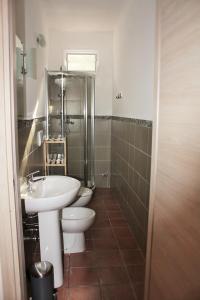 a bathroom with two toilets and a sink at La Macchia in Melendugno +103 photos