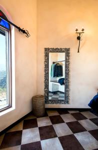 a mirror in a room with a checkered floor at The Orchard at Peora Estates in Mukteshwar