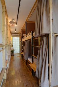 a hallway with bunk beds in a small room at Vessel Hostel in San Juan