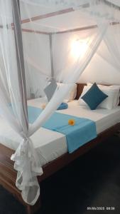 a bedroom with two beds with a canopy at Quiet Place villa with kitchen in Tangalle +63 photos
