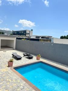 a swimming pool on the roof of a building at Luxury Haven- Near AC Marriott Hotel Kingston in Kingston