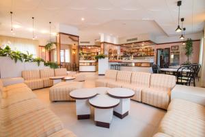 eine Lobby mit Sofas, Tischen und einer Bar in der Unterkunft Residence Hotel Amalfi in Lido di Savio