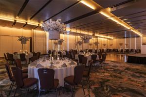 a banquet hall with white tables and chairs and chandeliers at Hilton Bogotá in Bogotá +115 photos