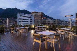 a deck with tables and chairs on a building at Hilton Bogotá in Bogotá