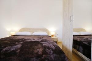 a bedroom with a bed with two white pillows at Villa Zvizda in Zadar +76 photos