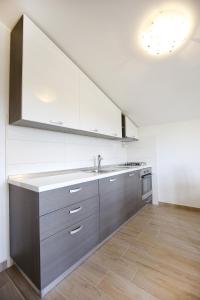 a kitchen with a sink and a stove at Villa Zvizda in Zadar