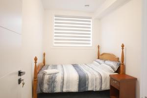 a bedroom with a bed and a window at 5003R New Luxury Walkout Suite Near Calgary University in Calgary