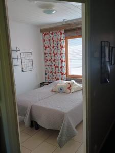 a small bedroom with a bed and a window at Holiday Home Lumikieppi in Äkäslompolo +34 photos