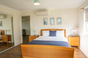 a bedroom with a large bed and two night stands at Horizon View Cottage in Bald Knob