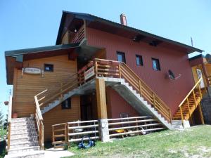 a building with stairs on the side of it at Apartments Anđela in Žabljak