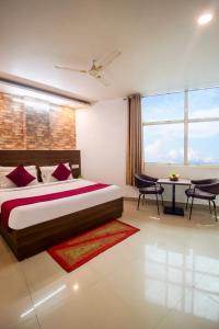 a bedroom with a bed and a table and chairs at HOTEL S R Palace - Free Airport Drop for Minimum 05 Nights Stay - 5 mins from IGI & Domestic Airport Delhi in New Delhi