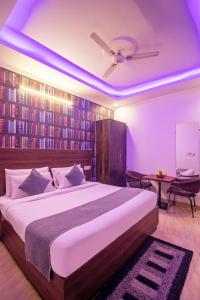 a bedroom with a large bed and a book wall at HOTEL S R Palace - Free Airport Drop for Minimum 05 Nights Stay - 5 mins from IGI & Domestic Airport Delhi in New Delhi