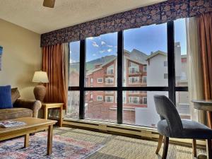 a living room with a large window with a view at King Suite with a View Pool Hot Tub Ski In-Out in Mount Crested Butte