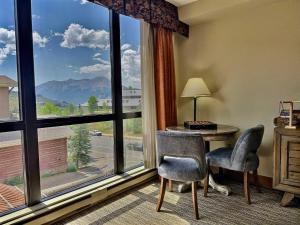 a room with a table and chairs and a large window at King Suite with a View Pool Hot Tub Ski In-Out in Mount Crested Butte