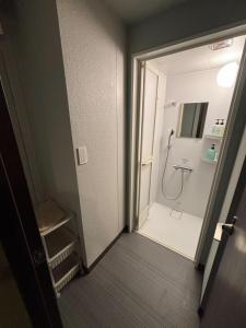 a bathroom with a shower and a toilet in it at Yoroi Asakusa Hotel in Tokyo +38 photos