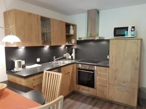 a kitchen with a sink and a stove top oven at Heulandhof in Bad Hindelang