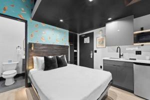 a bedroom with a large bed and a bathroom at Balboa Park Hotel Downtown Little Italy in San Diego +255 photos